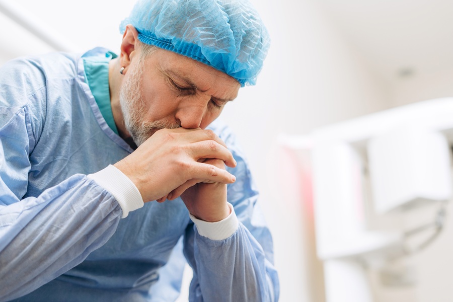 Portrait,Of,Tired,And,Stressed,Mature,Doctor,Wearing,Uniform,Thinking
