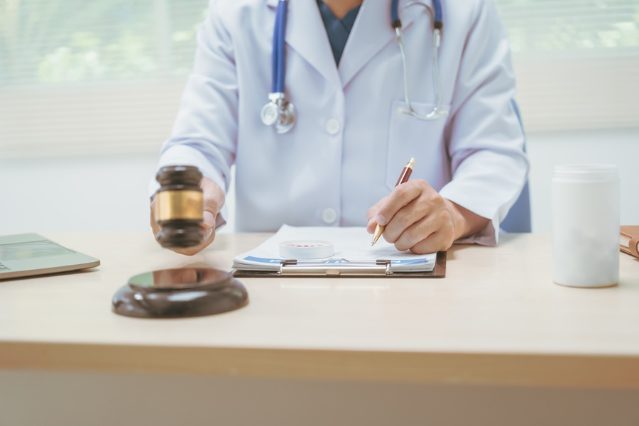 Male,Doctor,Working,At,A,Desk,In,A,Hospital,,Using