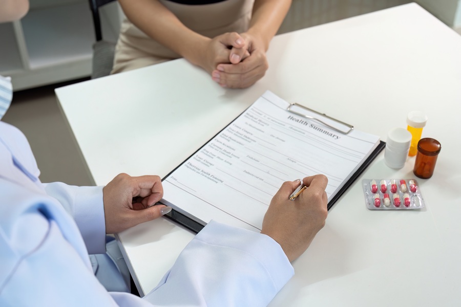 Healthcare,Consultation.,Doctor,Reviewing,Health,Summary,With,Patient,During,Medical
